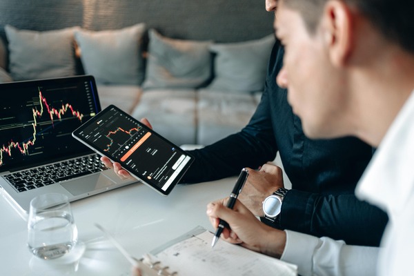 Person managing cryptocurrency wallets and trading data on a laptop